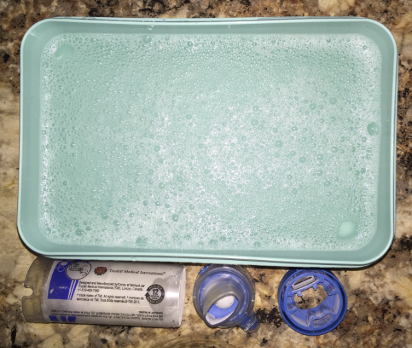 Plastic tub full of soapy water.