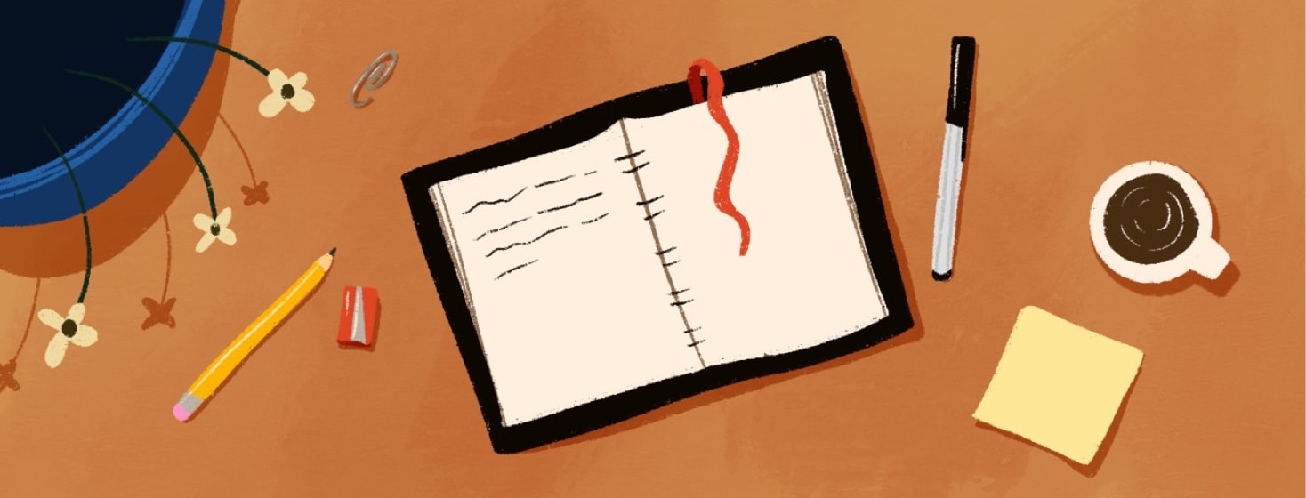 overhead view of a desk with a journal