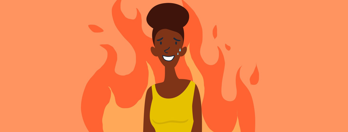 a woman stands in a wall of flames, sweating but smiling