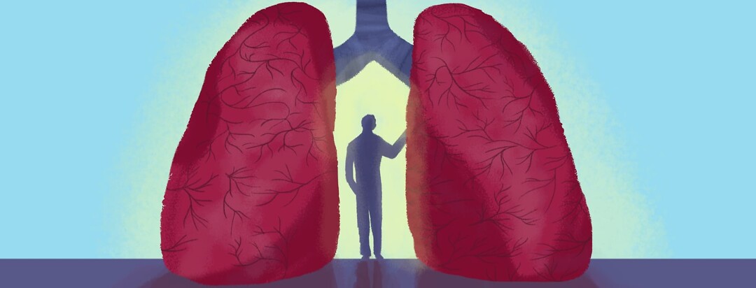 a person standing between lungs with the bronchi showing