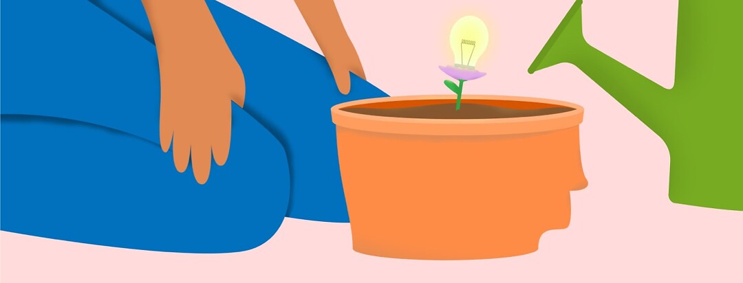 A person planting a flower in a head shaped pot and the flower bloomed a lightbulb