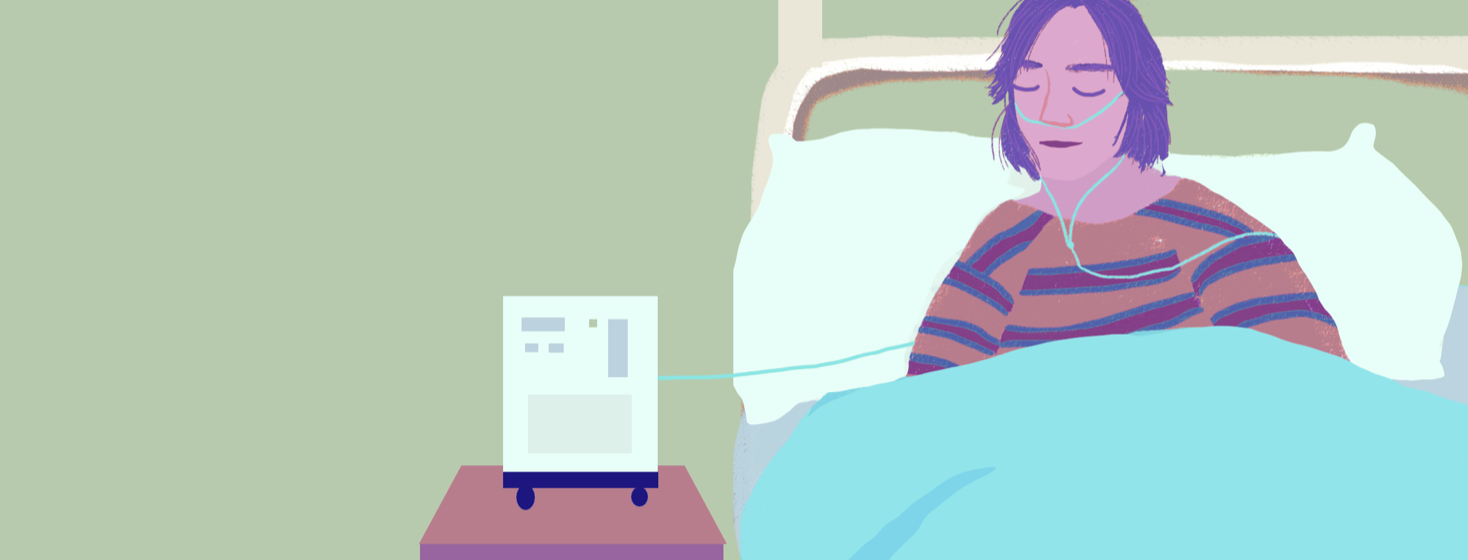 A woman in bed with an oxygen cannula