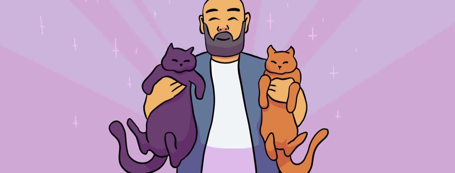 A smiling man holding two cats