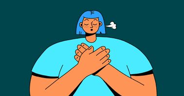 A woman holding her hands on her chest and breathing deeply